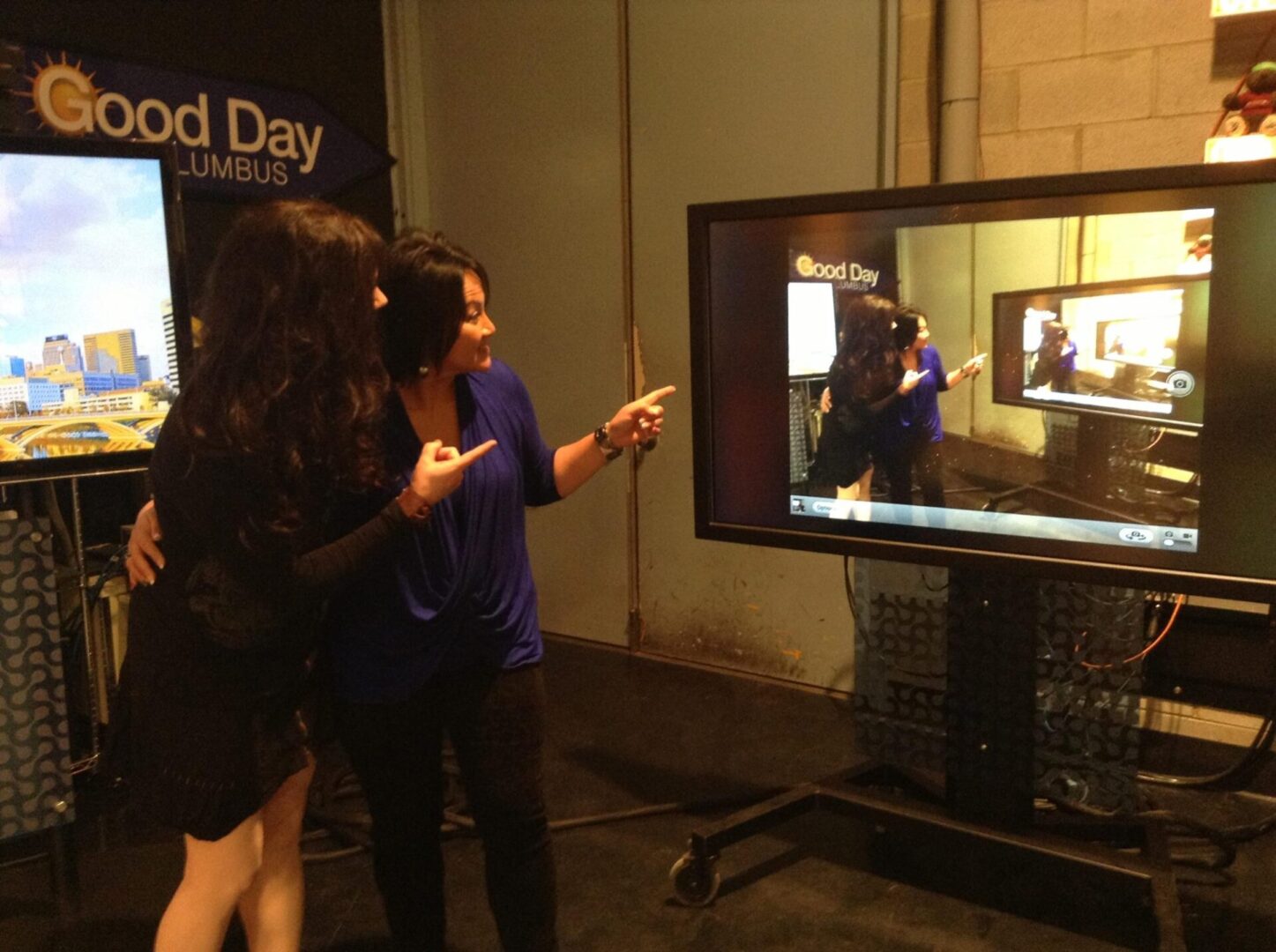 Two women are playing a video game on the tv.