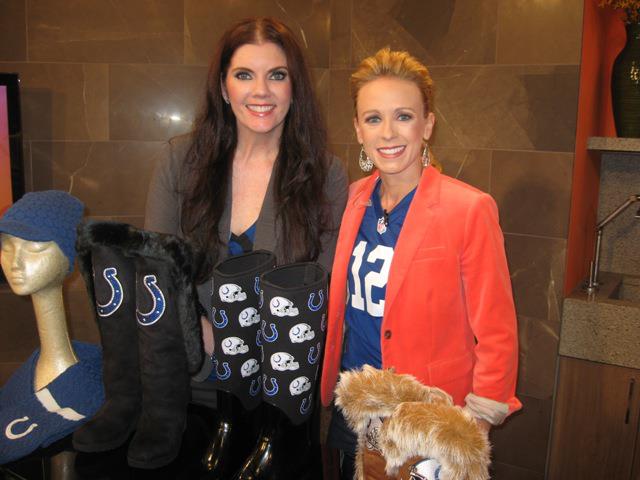 Two women standing next to each other holding a dog.