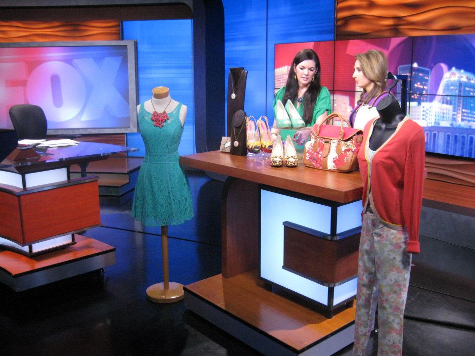 A woman standing in front of a mannequin on the set of a television show.