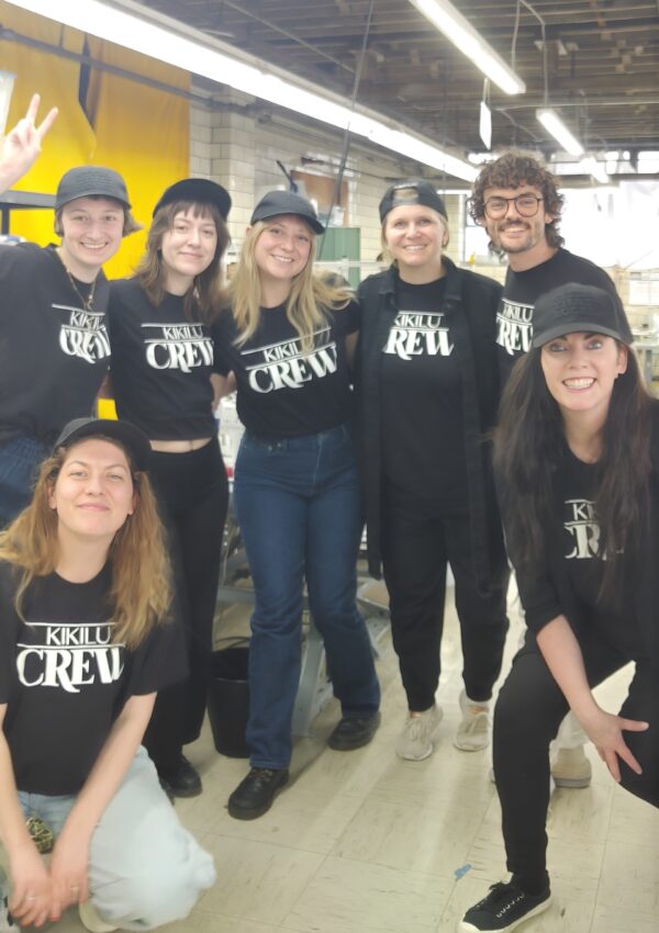 A group of people wearing black shirts and hats.